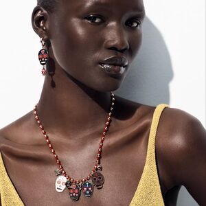 ENAMELED SKULL NECKLACES, EARRINGS AND RING SET